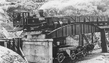 Public Works Train on the bridge unloading coal for Waihi. c.1904